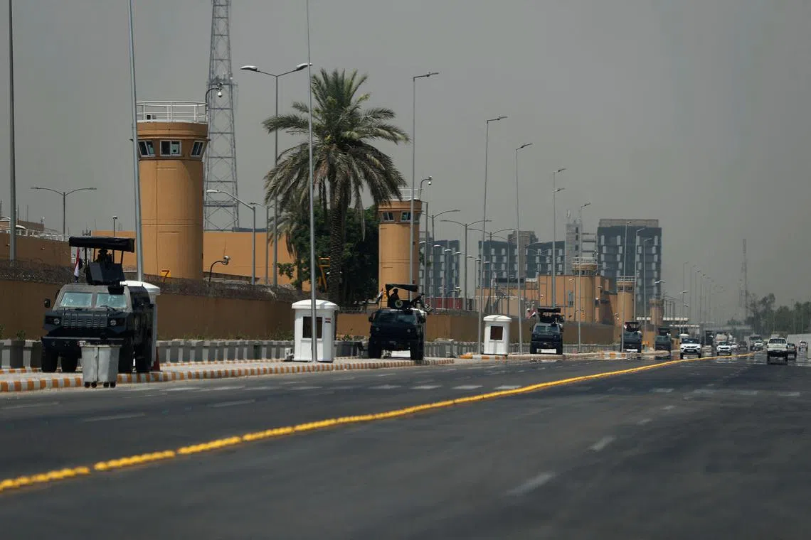 TOPSHOT - Armoured vehicles of the Iraqi Counter Terrorism Forces are deployed outside the US embassy building in Baghdad's Green Zone on June 12, 2025, after an announcement by a US official the previous day that staff levels at the diplomatic mission in Iraq were being reduced over security concerns. Despite reporting progress in earlier rounds of talks between Iran and the United States, tensions have reached a fever pitch this week as Washington moved non-essential staff from bases in the region following US media reports on June 11 that Israel appeared to be preparing an attack on Iran. (Photo by AHMAD AL-RUBAYE / AFP)