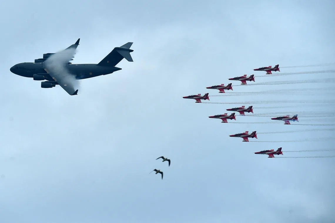 An Indian Air Force Boeing C17 Globe Master (L) flying past during the rehearsal for the upcoming Air Force Day celebrations in Prayagraj on Oct 5.