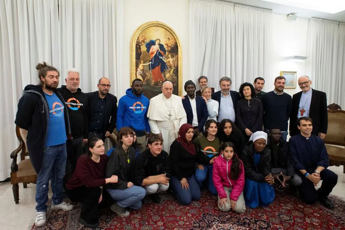 Pope Francis poses for a group photo as he meets with Mbengue Nyimbilo Crepin, nicknamed Pato, and the delegation from the Mediterranea Saving Humans, at the Vatican, November 17, 2023.   Vatican Media/­Handout via REUTERS/File Photo