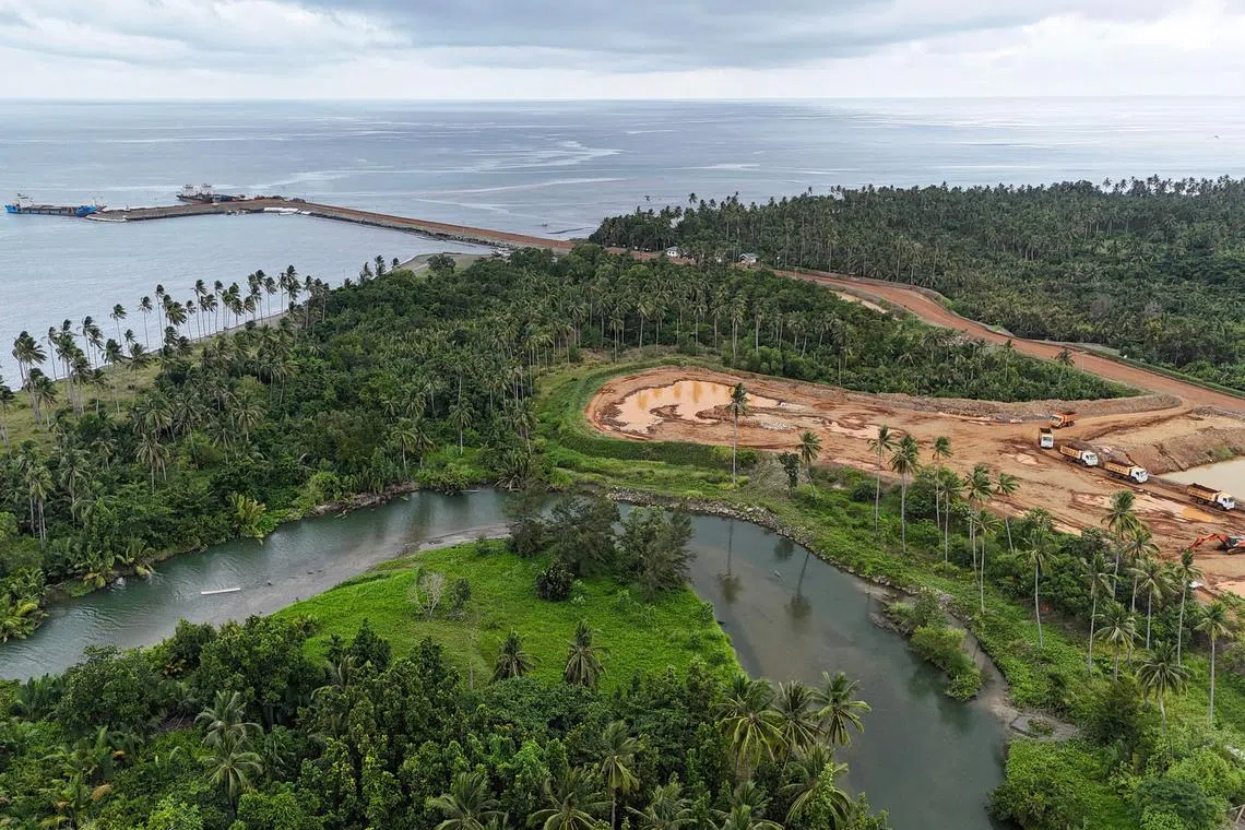 An aerial photo taken on May 24 shows the pier and stockpiles of nickel ore near the rice paddy of the Tambiling family in the village of Maasin, in Brooke's Point, Palawan province.