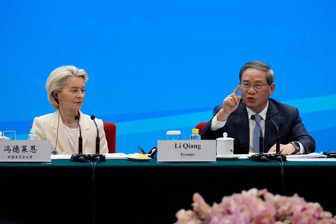 FILE PHOTO: Chinese Premier Li Qiang speaks as European Commission President Ursula von der Leyen looks on during the EU-China Business leaders symposium at the Great Hall of the People in Beijing, China, July 24, 2025. Mahesh Kumar A./Pool via REUTERS/File Photo