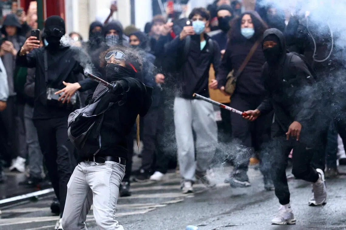 A few dozen masked protesters dressed in black threw rocks and other objects at police.