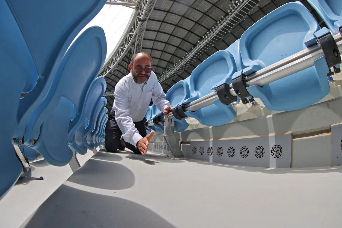 Saud Abdulaziz Abdul Ghani gives a tour of the cooling system at the al-Janoub Stadium on April 20, 2022 in Doha, which will host matches of the FIFA football World Cup 2022. - Ghani, known as "Dr Cool", worked for 13 years on the solar-powered cooling system that he says will keep the players and turf healthy and even eliminate body odour in a packed stadium. (Photo by KARIM JAAFAR / AFP)