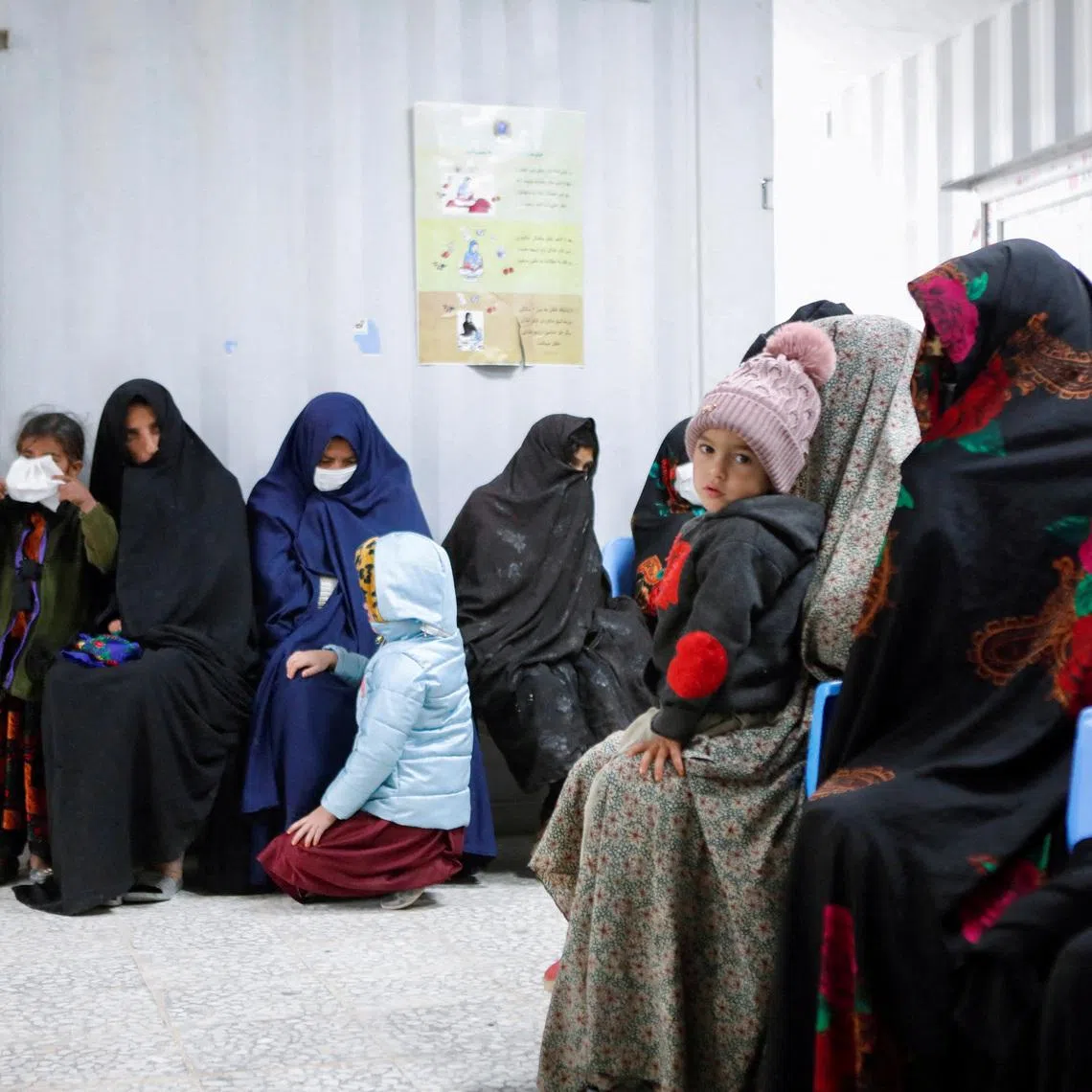 FILE PHOTO: Afghan women and children wait for their turn to see a doctor at Yaka Dokan health clinic run by nonprofit organization World Vision, in Yaka Dokan village, Herat, Afghanistan, October 23, 2024. REUTERS/Sayed Hassib/File Photo