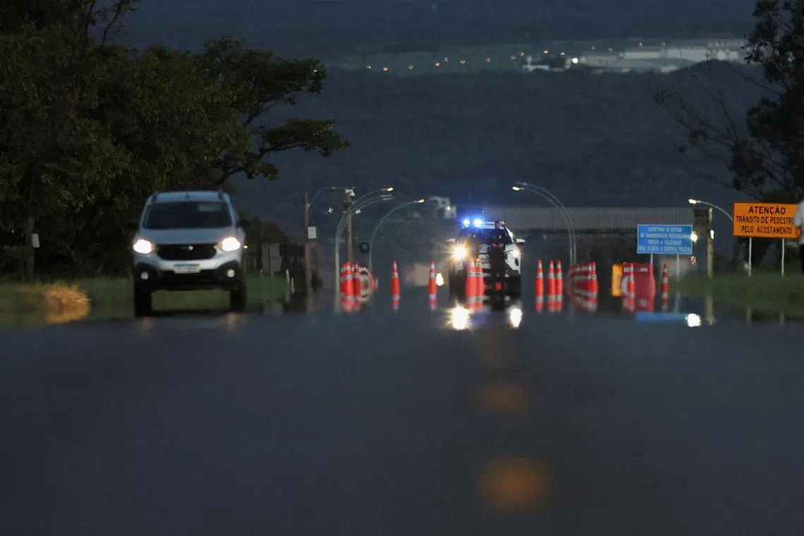 Police officers stand guard on the access road to the Papuda Penitentiary Complex after Supreme Court Justice Alexandre de Moraes ordered the transfer of former President Jair Bolsonaro, who was convicted by a Supreme Court majority of plotting a coup to remain in power after losing the 2022 election, in Brasilia, Brazil, January 15, 2026. REUTERS/Adriano Machado