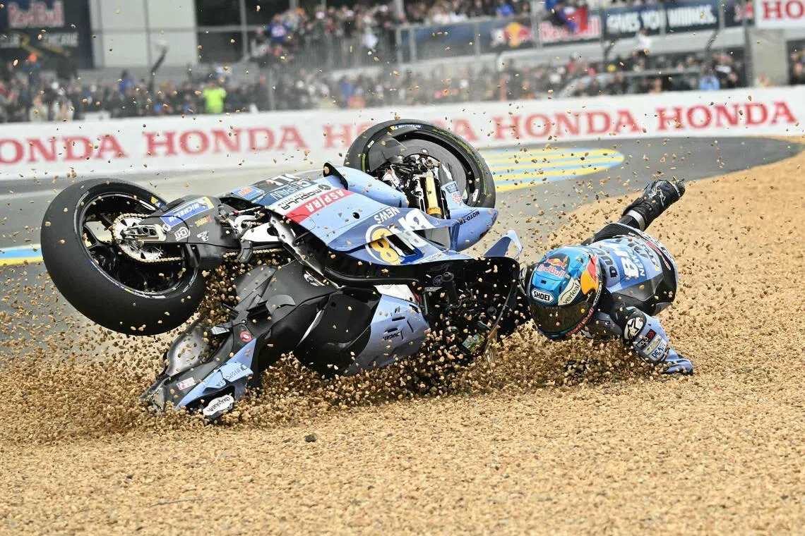 TOPSHOT - BK8 Gresini Racing MotoGP's Spanish rider Alex Marquez crashes out of the Moto GP Grand Prix of France at Le Mans, northwestern France, on May 10, 2026. (Photo by Loic VENANCE / AFP)