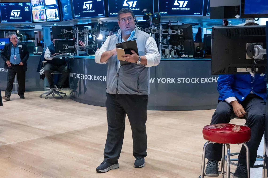 Traders work on the floor of the New York Stock Exchange, in New York City.