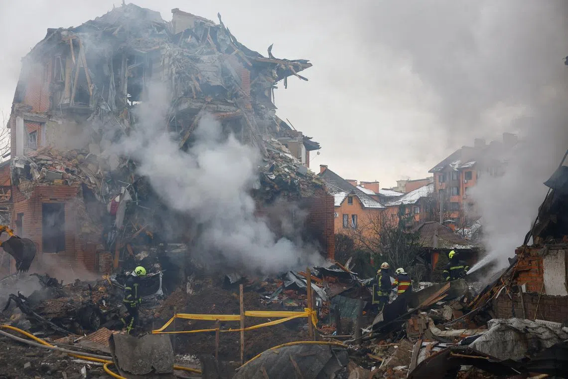 Firefighters work at the site of a residential building damaged during Russian drone and missile strikes, amid Russia's attack on Ukraine, in Kyiv, Ukraine, February 22, 2026. REUTERS/Valentyn Ogirenko