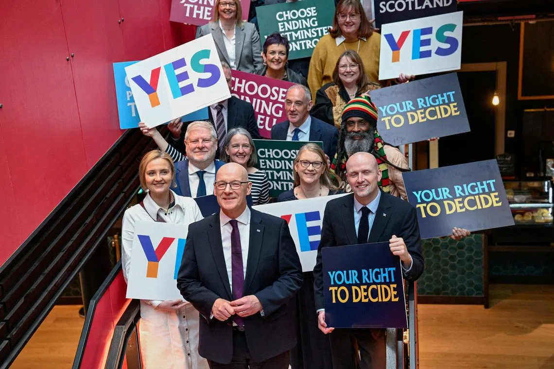 Scottish leader John Swinney (front row, centre) was expected to fall short of winning a majority of the 65 seats in the Scottish Parliament.