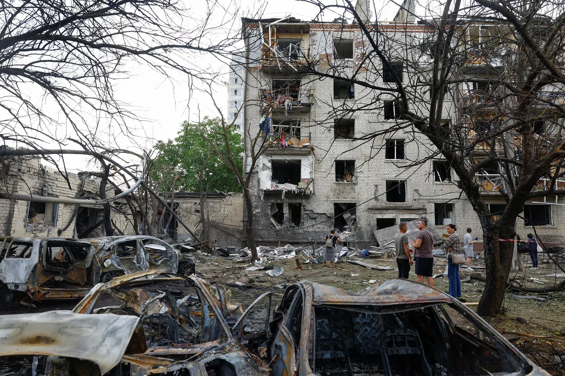 Residents stand in front of their apartment building damaged by a Russian missile strike in the town of Boryspil, amid Russia's attack on Ukraine, in Kyiv region, Ukraine September 1, 2026. REUTERS/Valentyn Ogirenko