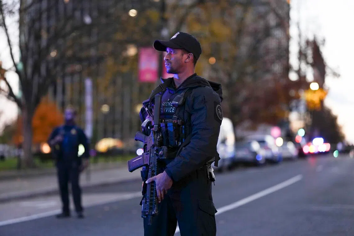 Law enforcers stand near where two National Guard soldiers were shot in Washington on Nov. 26, 2025.
