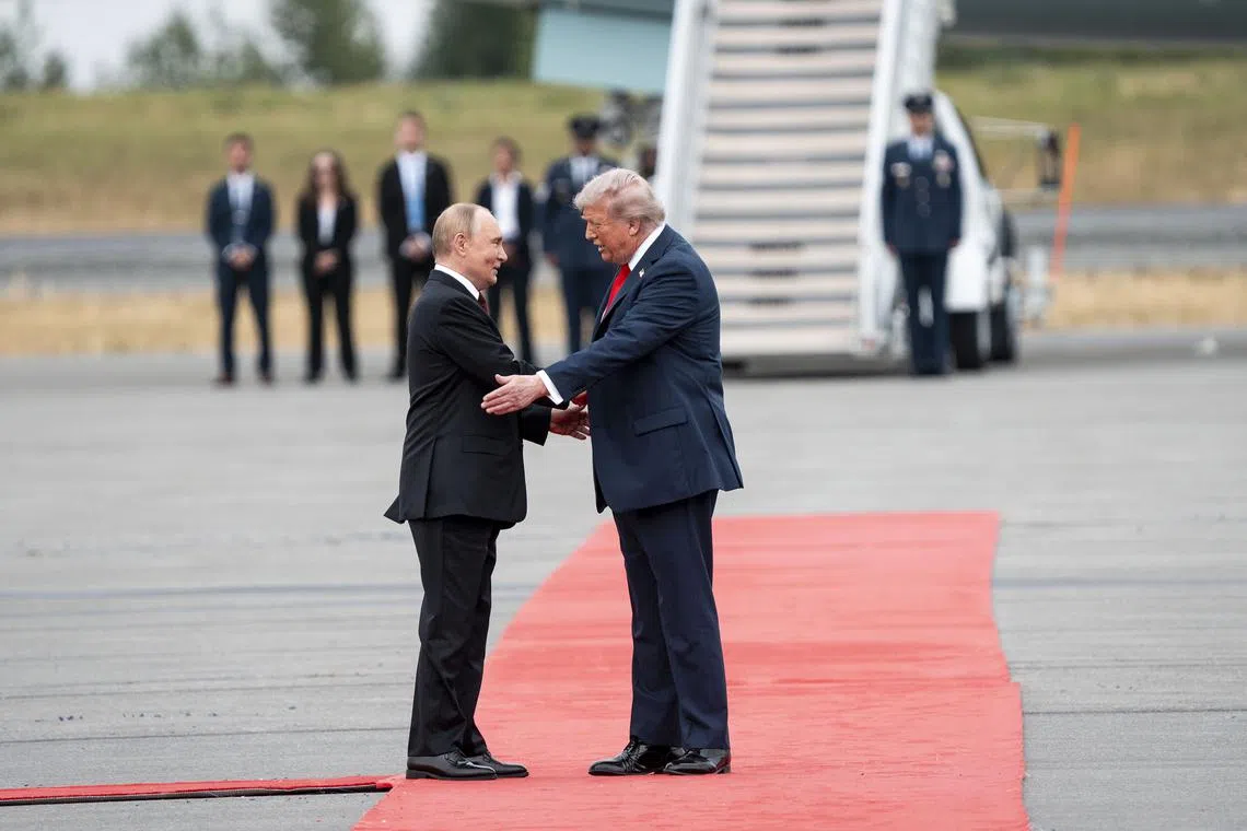 US President Donald Trump and Russia President Vladimir Putin shake hands as they met at Joint Base Elmendorf-Richardson in Anchorage, Alaska, on Aug 15.