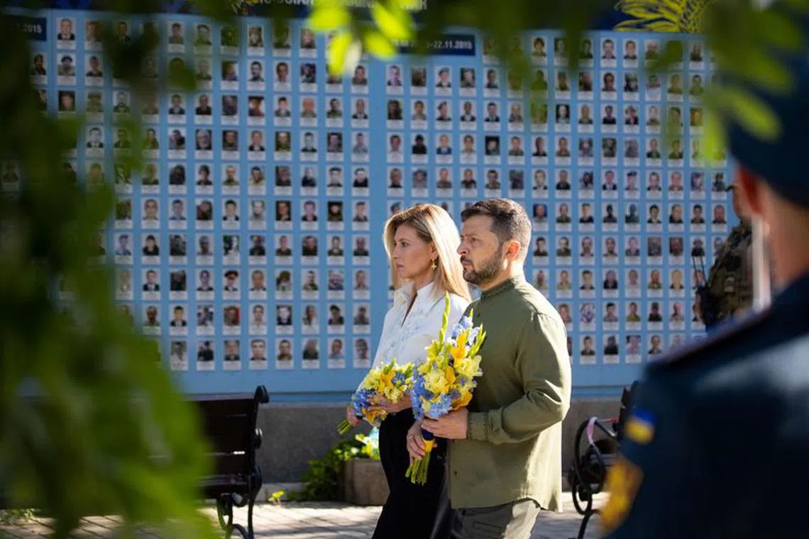 Ukraine's President Volodymyr Zelenskiy and his wife Olena lay flowers at the Memory Wall of Fallen Defenders of Ukraine, amid Russia's attack on Ukraine, during celebrations marking Independence Day, in Kyiv, Ukraine August 24, 2023.   Ukrainian Presidential Press Service/Handout via REUTERS/File Photo