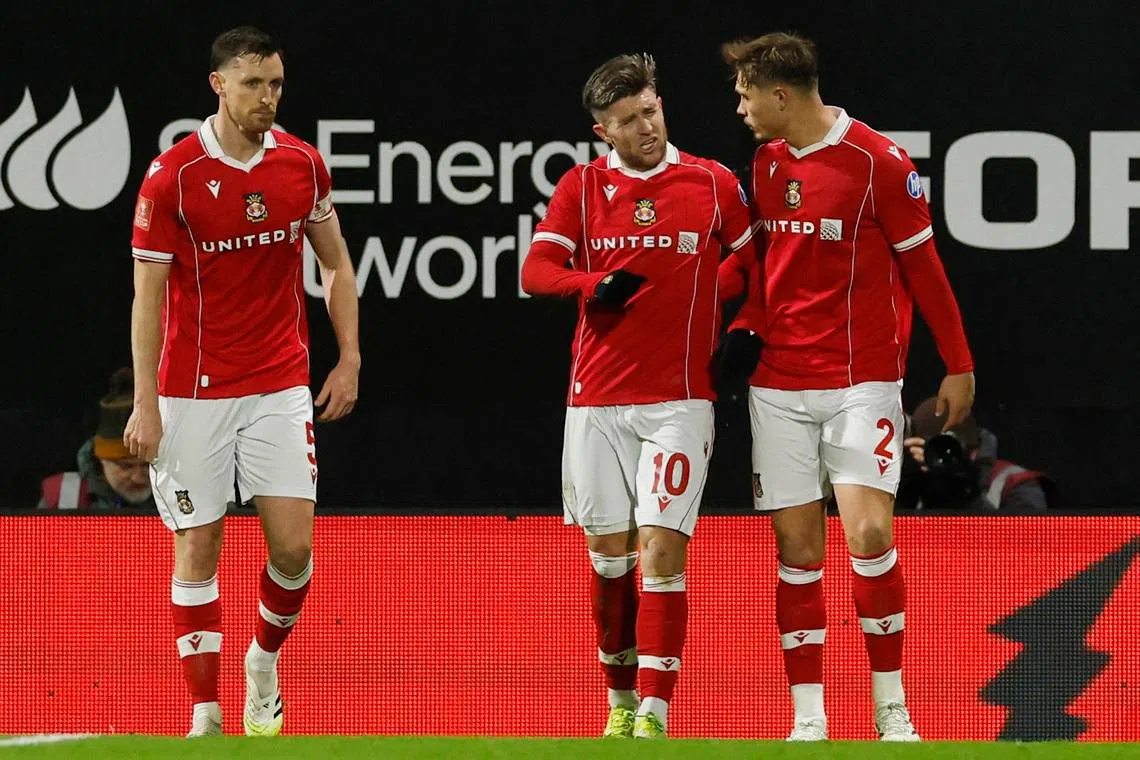 Soccer Football -  FA Cup - Fourth Round - Wrexham v Ipswich Town  - SToK Racecourse, Wrexham, Wales, Britain - February 13, 2026 Wrexham's Josh Windass celebrates scoring their first goal with Wrexham's Callum Doyle Action Images via Reuters/Jason Cairnduff
