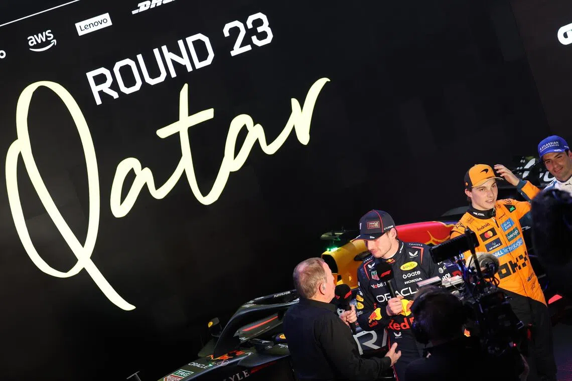 Race winner Max Verstappen (second from left), McLaren's Oscar Piastri and Williams' Carlos Sainz (far right) at post-race interviews after the Qatar Grand Prix.