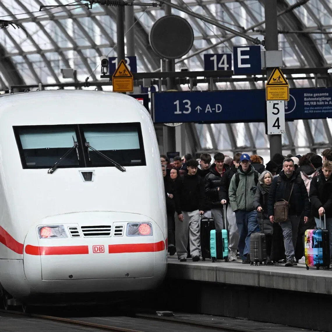 An ICE (Inter City Express) train by German railway operator Deutsche Bahn (DB) is pictured on March 27, 2026 at the main train station in Berlin. (Photo by RALF HIRSCHBERGER / AFP)