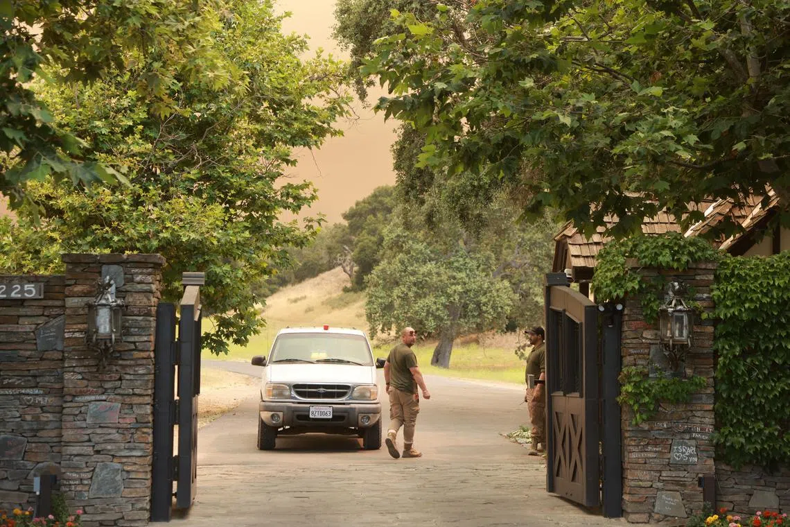 Firefighters man the entrance to the late pop star Michael Jackson’s Neverland Ranch in Los Olivos, California.