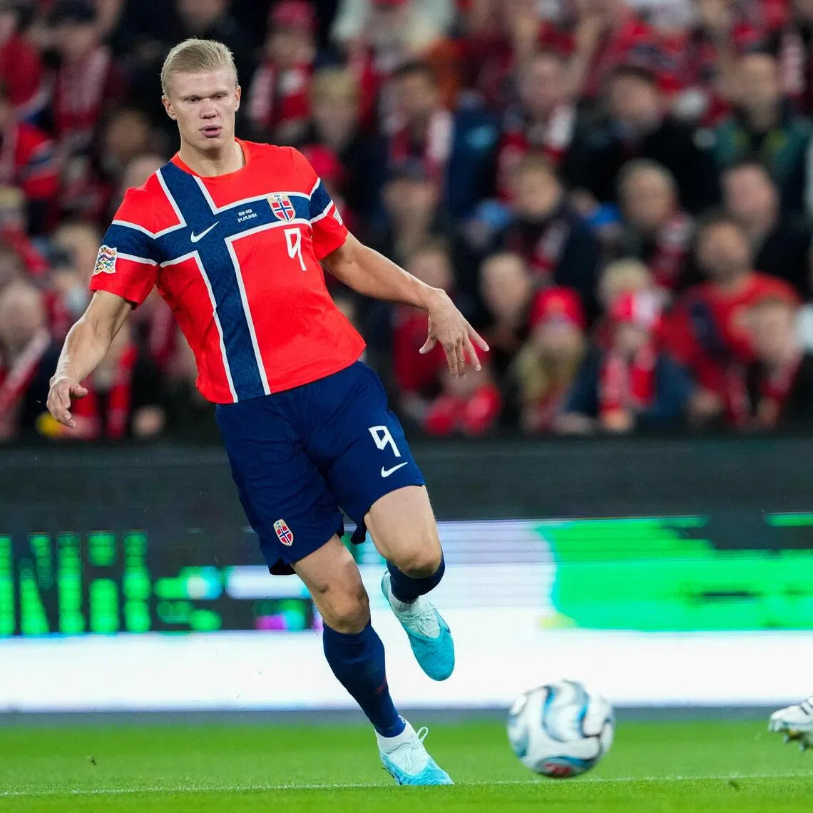 Norway’s Erling Haaland (left) in action against Denmark, in Oslo on Sept 24. He took his tally for the national team to 64 goals in 56 appearances - eclipsing Zlatan Ibrahimovic’s 62 goals in 122 matches for Sweden.