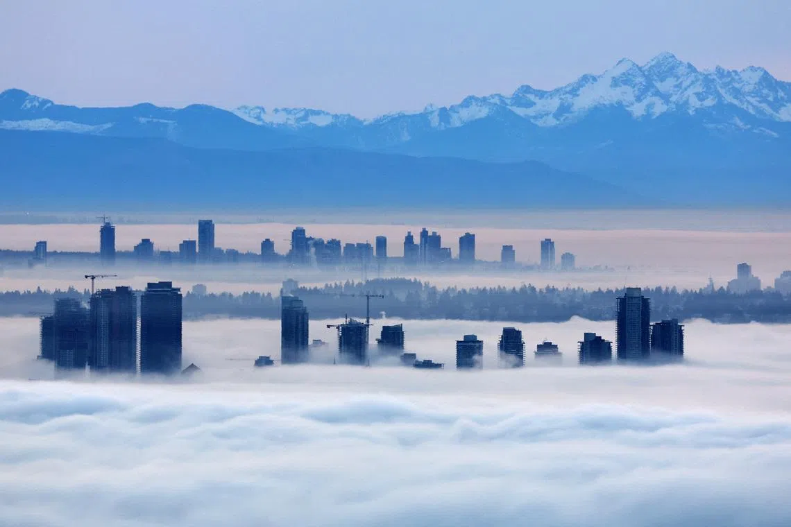 Building tops in Burnaby and Surrey rising above a thick layer of fog at dawn as a ridge of high pressure creates a coastal temperature inversion, as seen from Cypress Mountain in West Vancouver, British Columbia, Canada on Jan 20, 2026. 