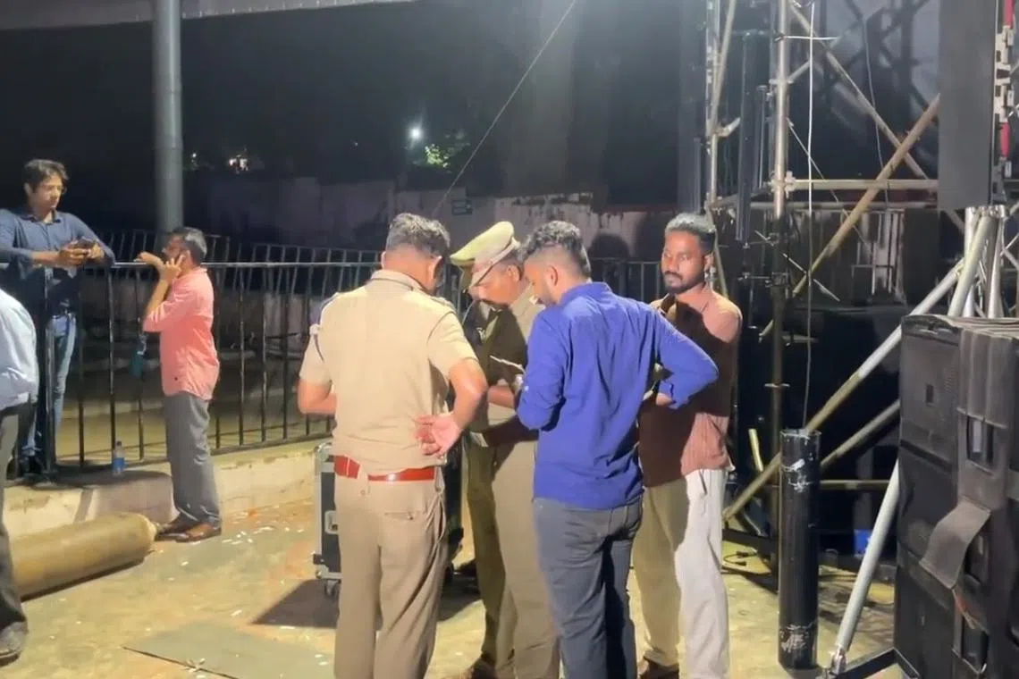 Police officers speak to the media after a stampede at an outdoor auditorium at the Cochin University of Science and Technology.