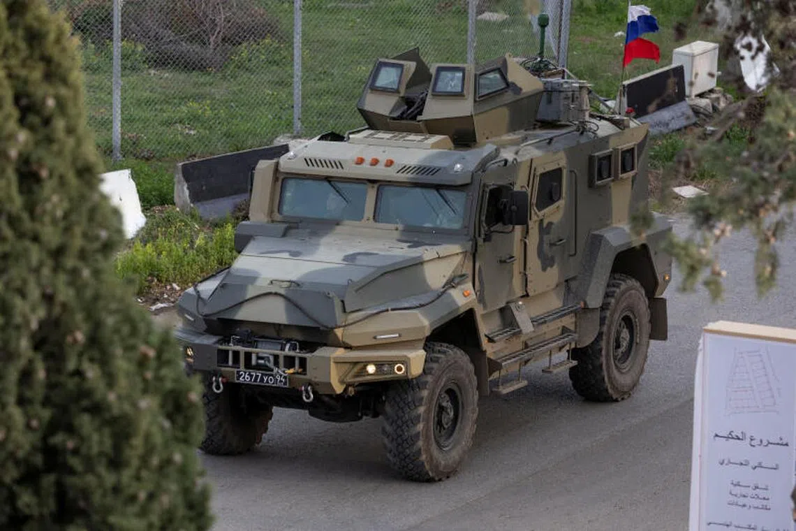 A Russian military vehicle heads towards Hmeimim air base in Syria's coastal Latakia, Syria, December 15, 2024. REUTERS/Umit Bektas