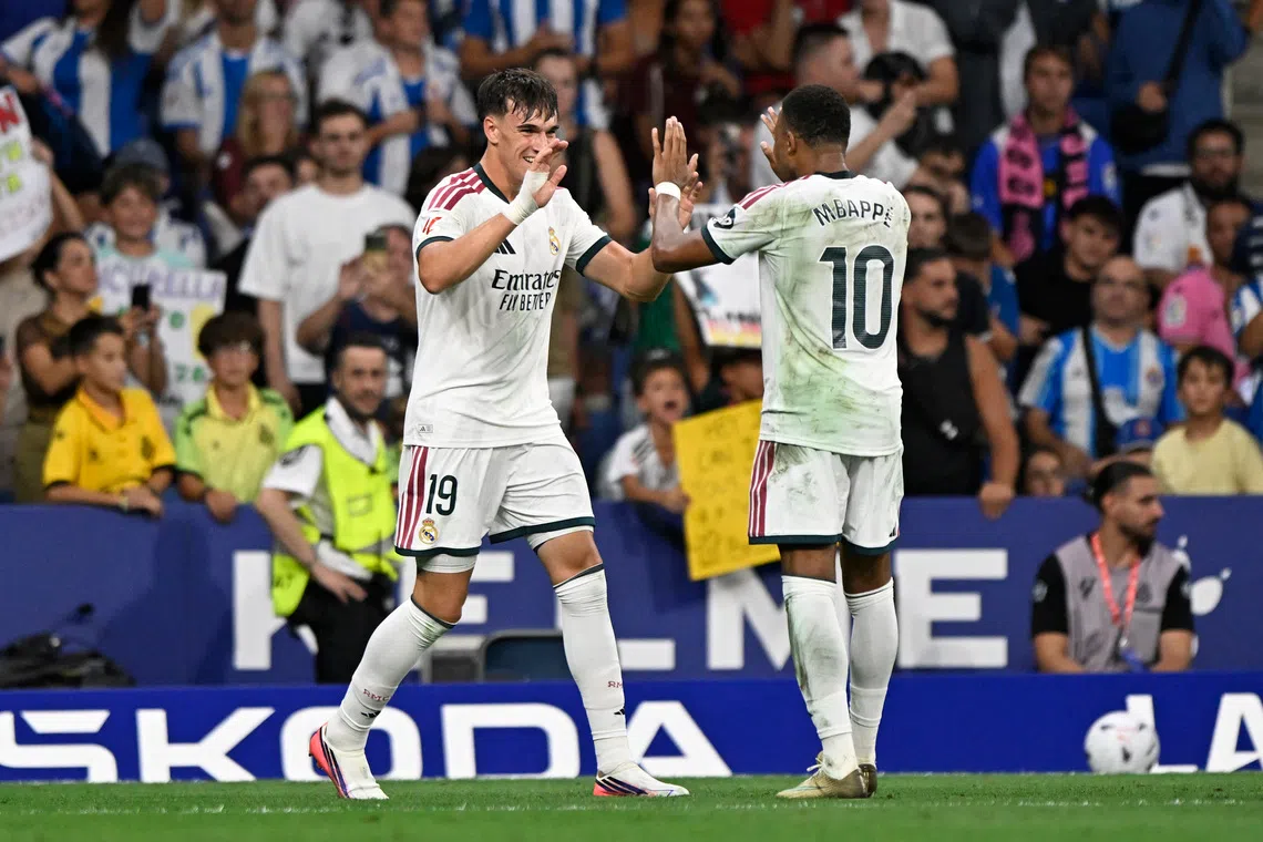 Real Madrid’s Carlos Espi celebrates scoring their second goal with Kylian Mbappe.