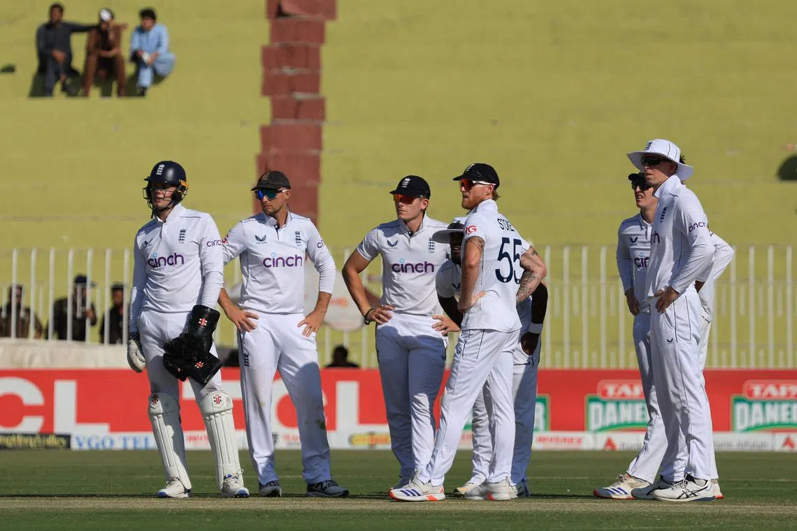 FILE PHOTO: Cricket - Third Test - England v Pakistan - Rawalpindi Cricket Stadium, Rawalpindi, Pakistan - October 25, 2024  England's Joe Root and Ben Stokes with teammates during a review REUTERS/Akhtar Soomro/File Photo
