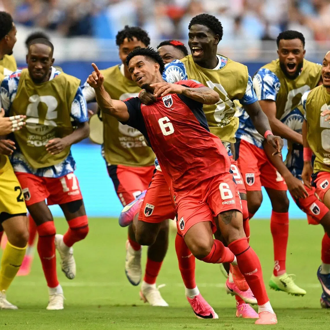 Cape Verde's midfielder Kevin Pina celebrates with teammates after scoring his team's first goal during the 2-2 draw against Uruguay at the Miami Stadium.