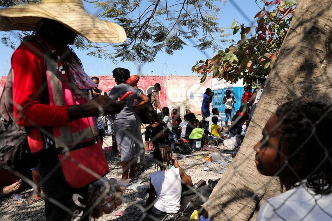 FILE PHOTO: People fleeing violence arrive at a Haitian National Police station, following a shootout between rival gangs, in Port-au-Prince, Haiti, February 12, 2024. REUTERS/Ralph Tedy Erol/File Photo