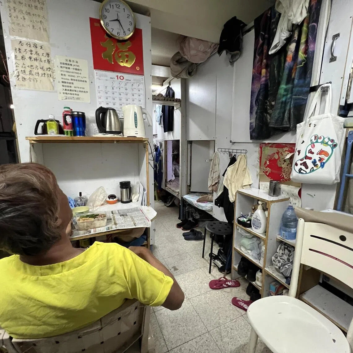 An odd-job worker has his dinner at the communal area of his “coffin home” in Cheung Sha Wan, Hong Kong.

