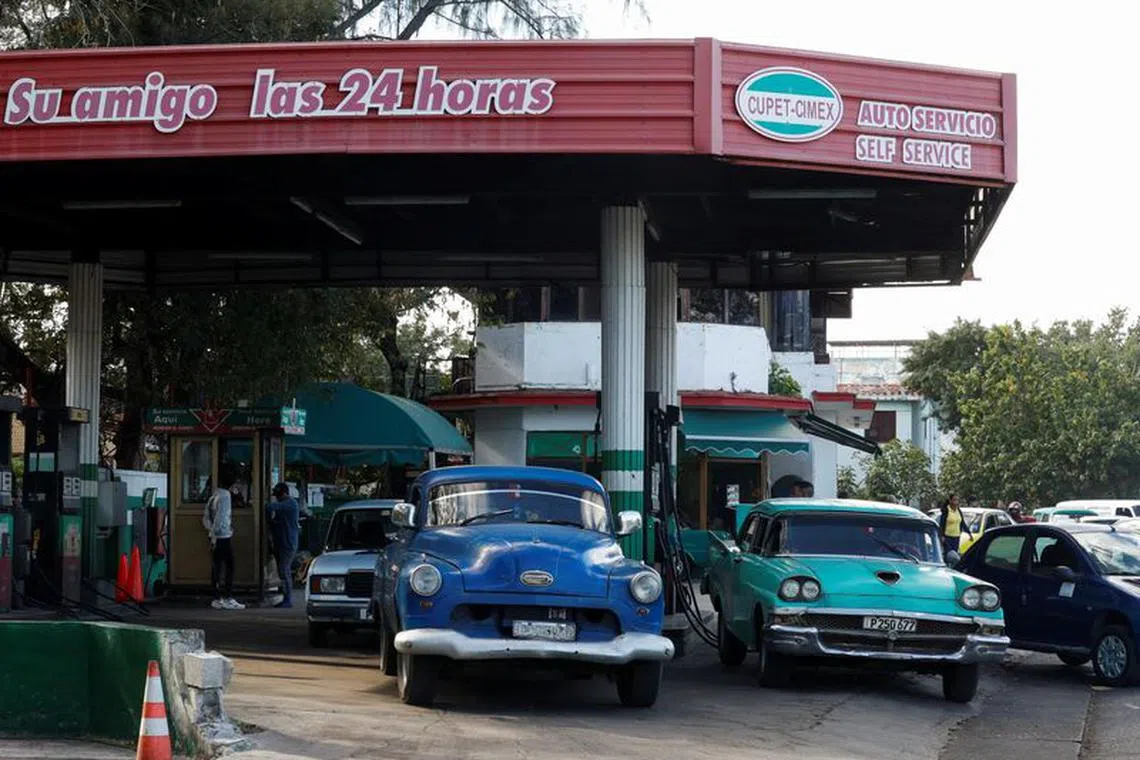 People stand in line with their cars to fill up on fuel after Cuba's government put off a five-fold increase in gasoline prices planned for February 1 due to a cyberattack, according to Economy Vice Minister Mildrey Granadillo, in Havana, Cuba January 31, 2024. REUTERS/Yander Zamora