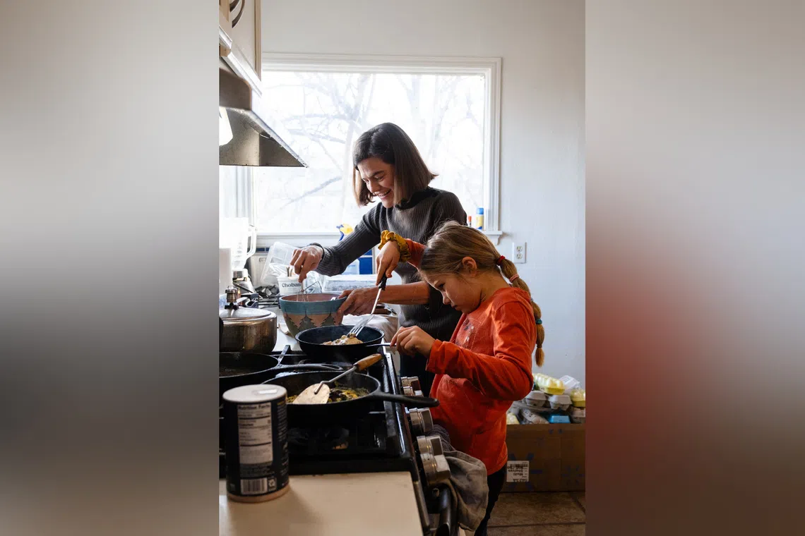 Parenting expert Michaeleen Doucleff cooking pancakes with her daughter, Rosy, at home.