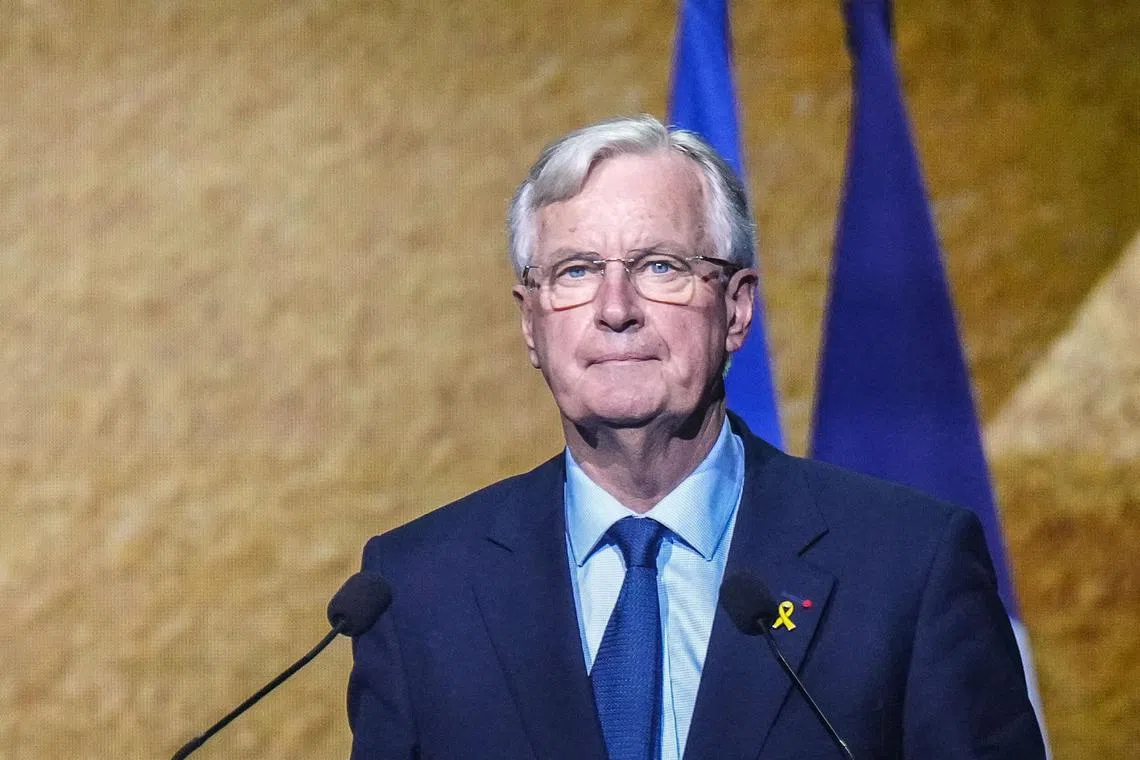 TOPSHOT - French Prime Minister Michel Barnier delivers a speech during a ceremony organised by the Council of French Jewish Institutions (CRIF) to pay tribute to the victims of Hamas' October 7, 2023 attacks on Israel, on the event's first anniversary, in Paris, on October 7, 2024. (Photo by Dimitar DILKOFF / AFP)