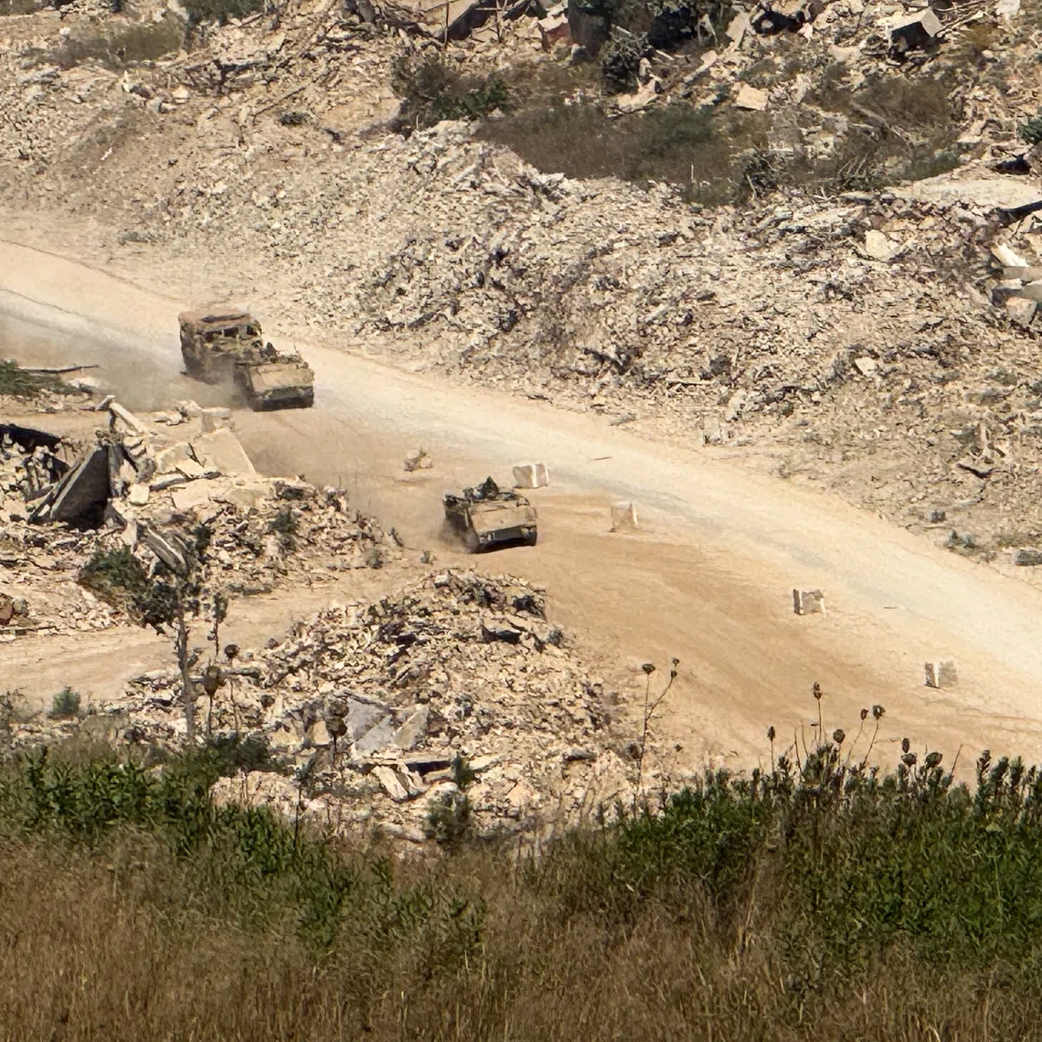 Israeli vehicles driving on a road in southern Lebanon on Aug 6.