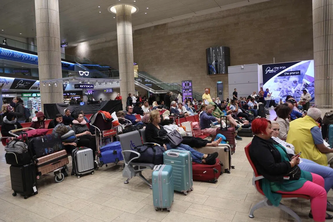 Passengers wait at Ben Gurion Airport near Tel Aviv, Israel, on Oct 7, as flights are cancelled due to the Hamas attack. 