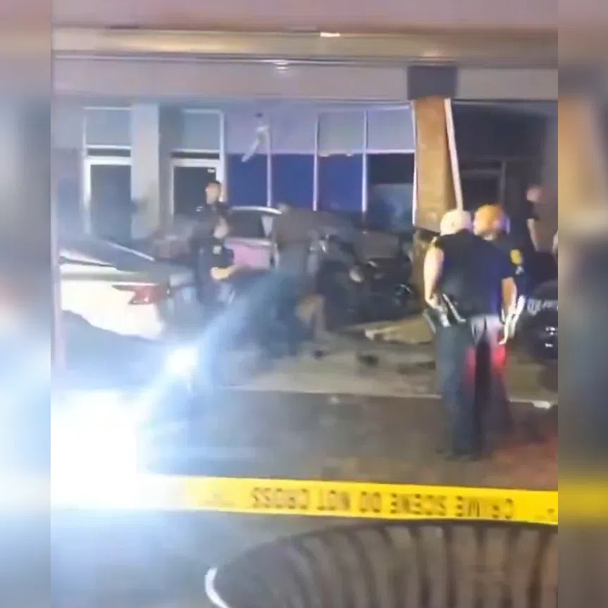 Video shared on social media showed a car on a sidewalk, its front end crumpled against the exterior of a building.