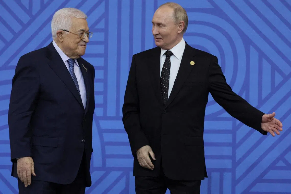 Russia's President Vladimir Putin and President of the Palestinian Authority, Mahmoud Abbas take part in an official welcoming ceremony for delegations' heads at the BRICS summit in Kazan, Russia, 23 October 2024.  MAXIM SHIPENKOV/Pool via REUTERS