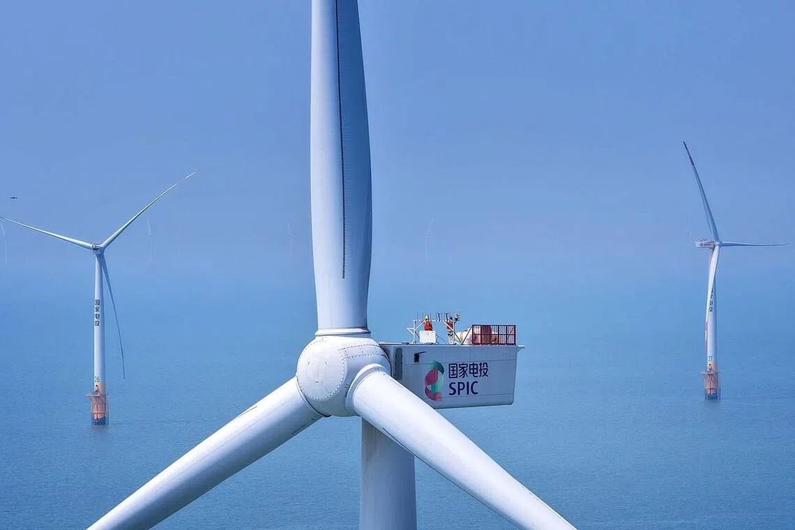 Workers carrying out routine maintenance on wind turbines at the Rudong H4 offshore wind farm in Rudong, China’s eastern Jiangsu province on June 10.