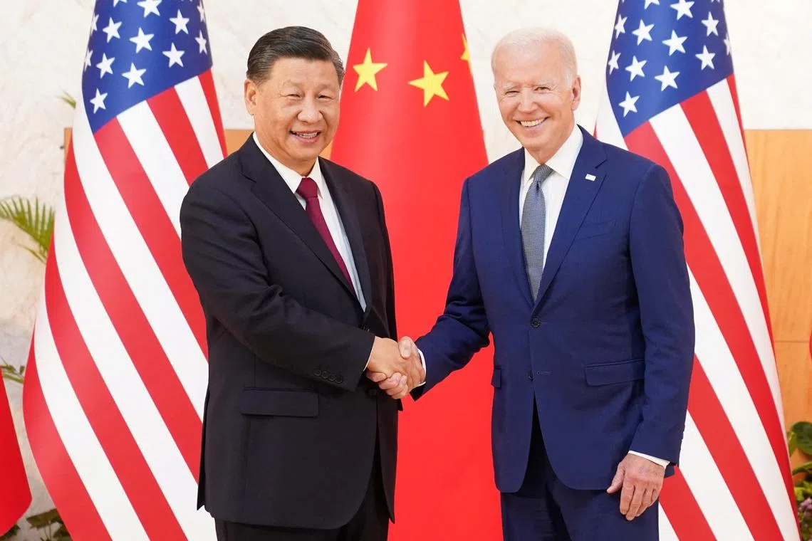 U.S. President Joe Biden shakes hands with Chinese President Xi Jinping as they meet on the sidelines of the G20 leaders' summit in Bali, Indonesia, November 14, 2022.  