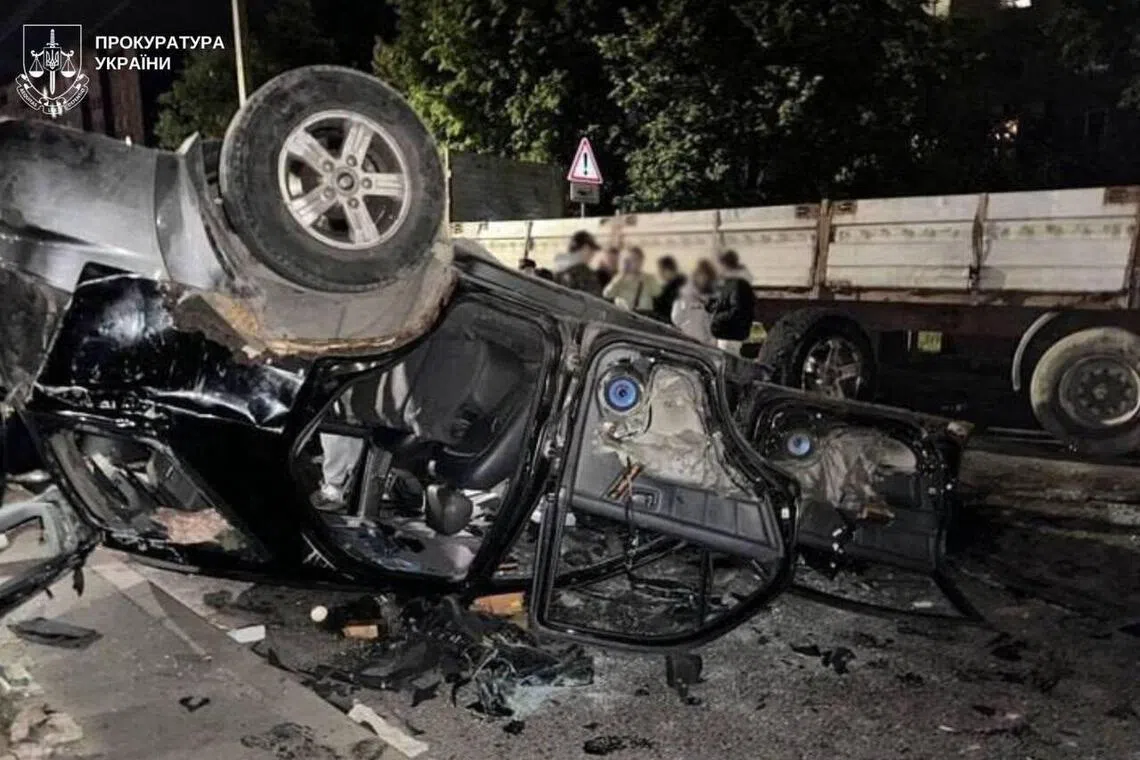 An overturned army conscription vehicle in Lviv following unrest that erupted after officers detained a man suspected of evading military service and took him to a draft centre on July 8.