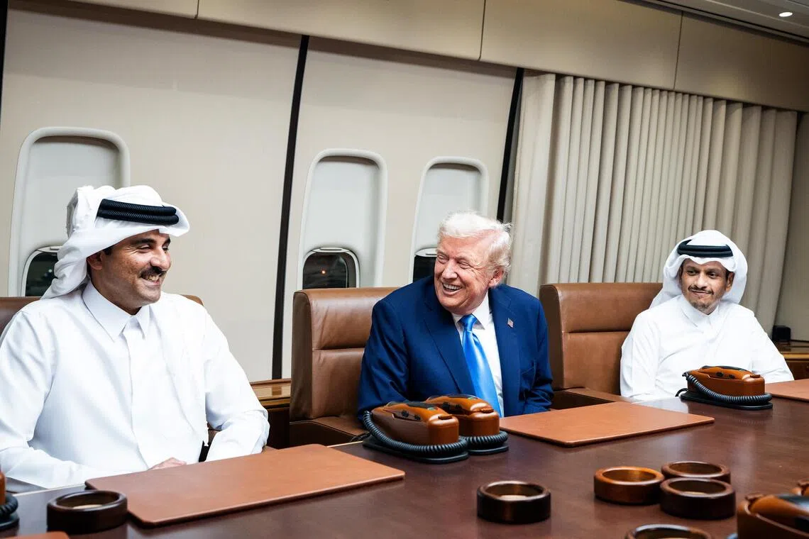 President Donald Trump (centre) meeting with Emir of Qatar Tamim bin Hamad Al Thani (left) and Qatari Prime Minister Mohammed bin Abdulrahman bin Jassim Al Thani aboard Air Force One on Oct 25, during a refuelling stop before continuing to Kuala Lumpur, Malaysia.
