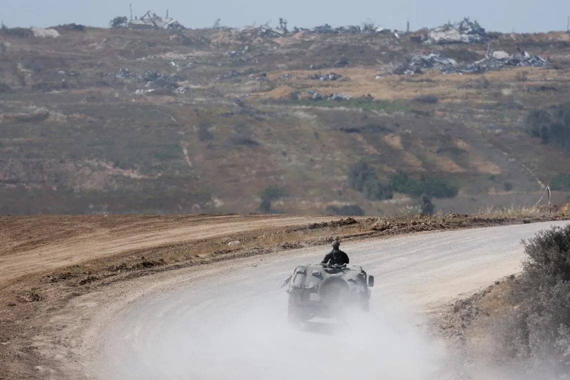 FILE PHOTO: An Israeli military vehicle manoeuvres, near the Israel-Gaza border, amid the ongoing conflict between Israel and the Palestinian Islamist group Hamas, in Israel, April 15, 2024. REUTERS/Amir Cohen/File Photo