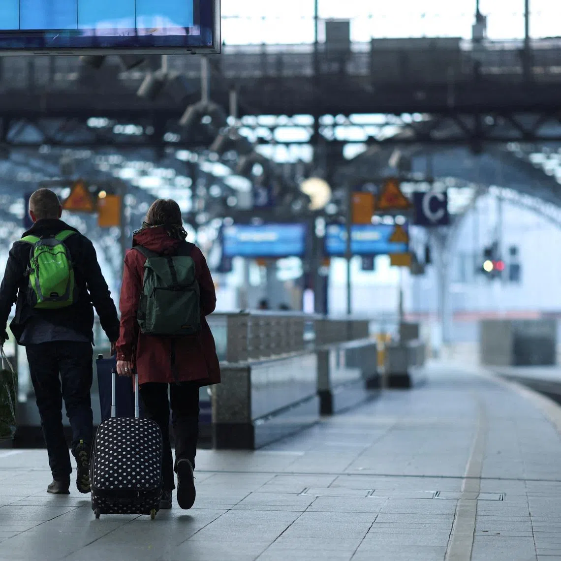 People walk on the platform of the empty Cologne Central Station in Cologne, Germany, April 21, 2023. REUTERS/Thilo Schmuelgen/File Photo