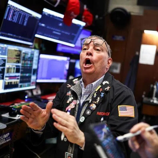 Traders work on the floor of the New York Stock Exchange at the opening bell on March 2, 2026, in New York City. 