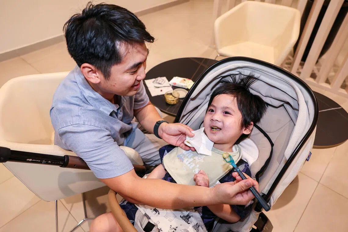 Keltonn Soh feeding his son Oliver mashed avocado and banana for dinner.