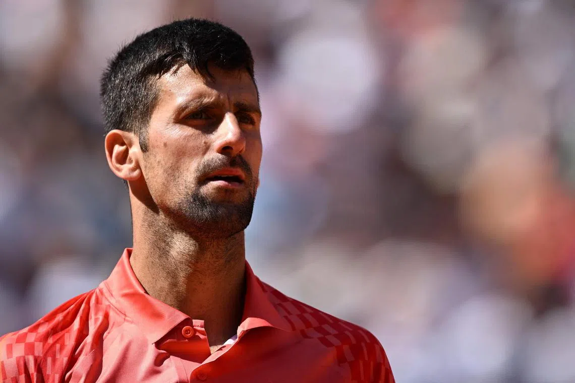 Serbia's Novak Djokovic looks on as he plays against US Aleksandar Kovacevic during their men's singles match on day two of the Roland-Garros Open tennis tournament at the Court Philippe-Chatrier in Paris on May 29, 2023. (Photo by Emmanuel DUNAND / AFP)