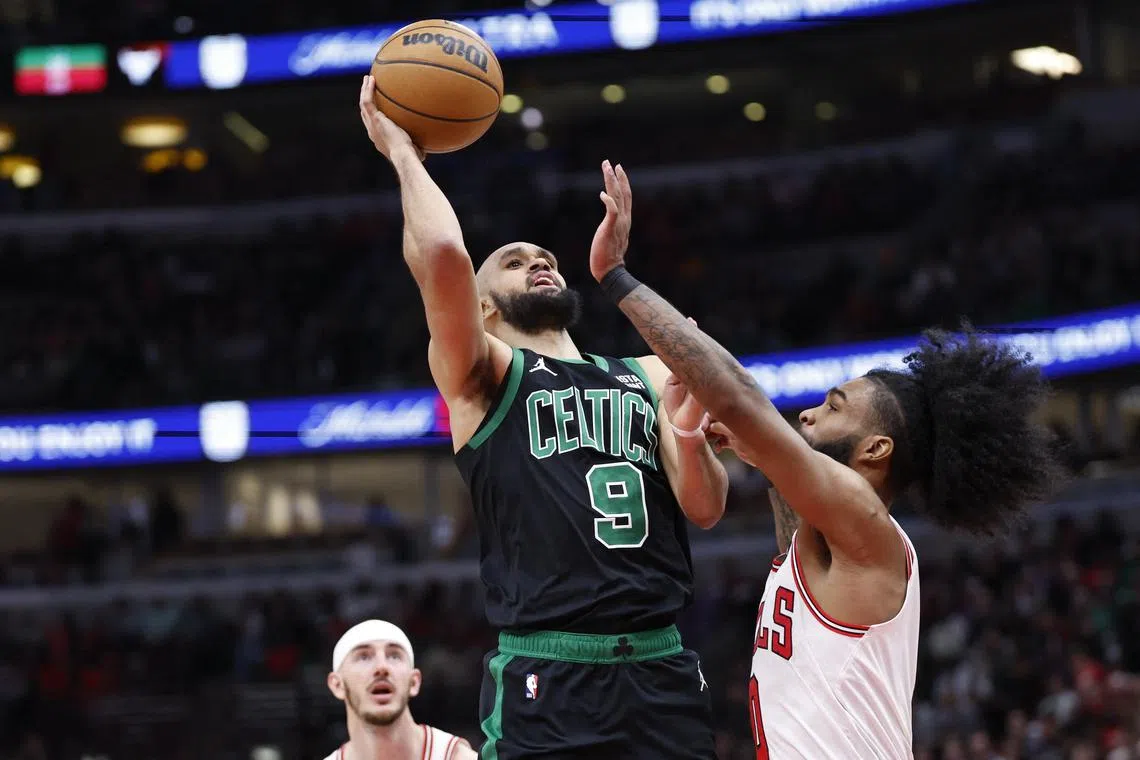 Boston Celtics guard Derrick White shoots against Chicago Bulls guard Coby White during the second half at United Centre.