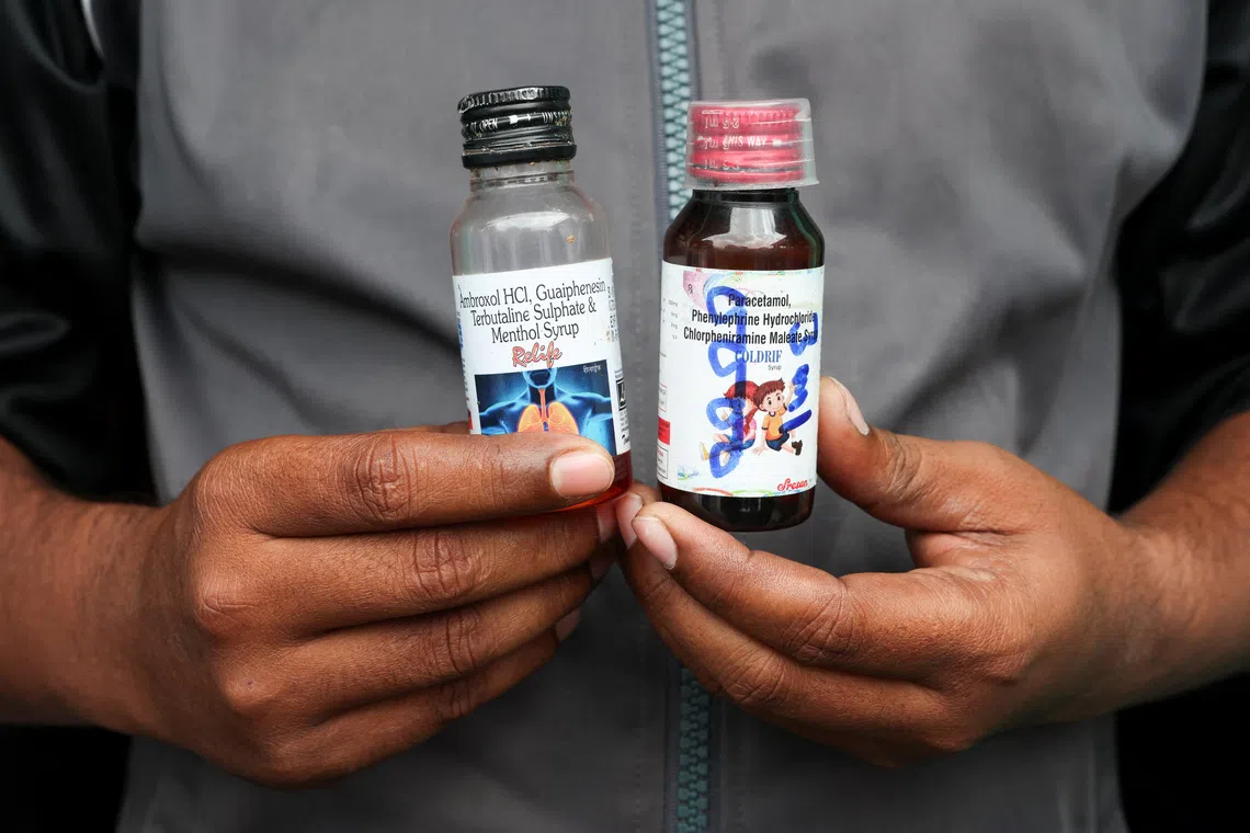 Saddam Mansuri, the father of two, shows bottles of Coldrif, linked to the deaths of several children and a Relife cough syrup, which is not linked to any deaths, but Indian authorities have asked people to avoid it, which he had been giving his one-year-old child, in Parasia, Madhya Pradesh, India, October 10, 2025. REUTERS/Priyanshu Singh/File Photo