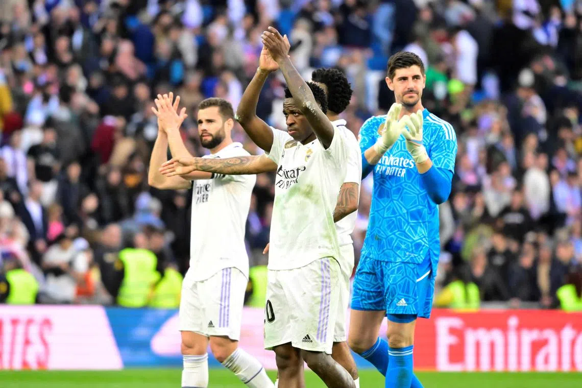 (From left) Real's Nacho Fernandez, Vinicius Junior and Thibaut Courtois celebrate victory.