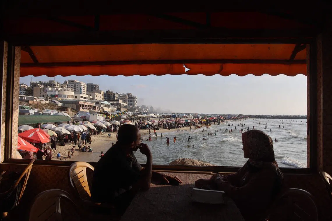 Palestinians gathering at the beach in Gaza City to escape the heat and displacement tents amid the ongoing war between Israel and Palestinian militants, on June 8, 2025.
